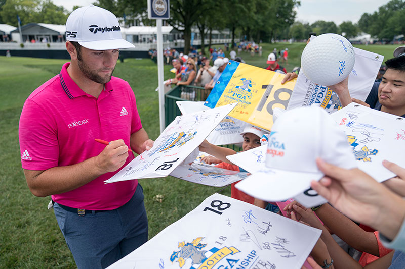Jon Rahm signs for fans at the 2018 PGA Championship at Bellerive.
