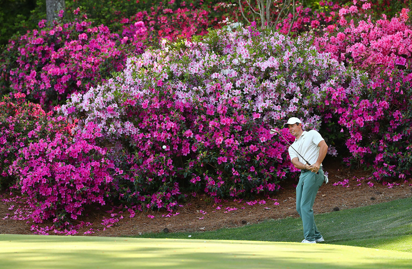 Rory McIlroy plays a shot from off the green during a practice round at the 2018 Masters.