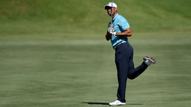 Tiger Woods celebrates big putt, chance to play weekend at Players